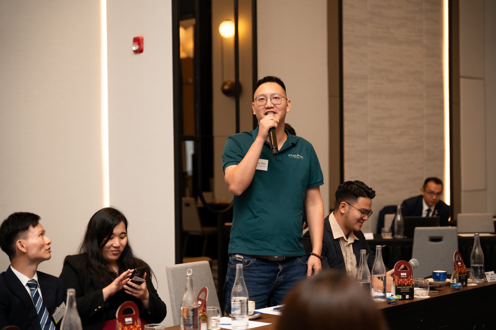 Polar Beh speaking at a business networking meeting.